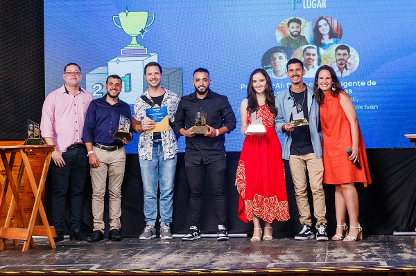 Equipe do 'PavimentAI: Detecção Inteligente de Patologias em Rodovias' recebendo o prêmio da categoria 'Tive uma ideia'